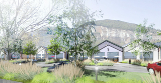 Exterior view from the street onto the built modules and the landscape in the background.